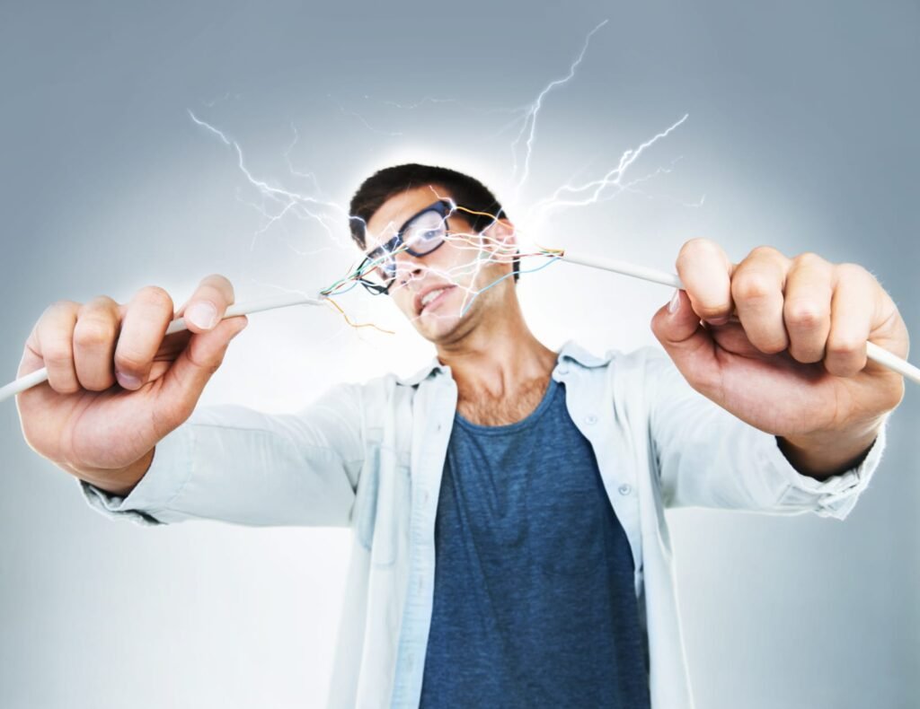 technician holding two live wires