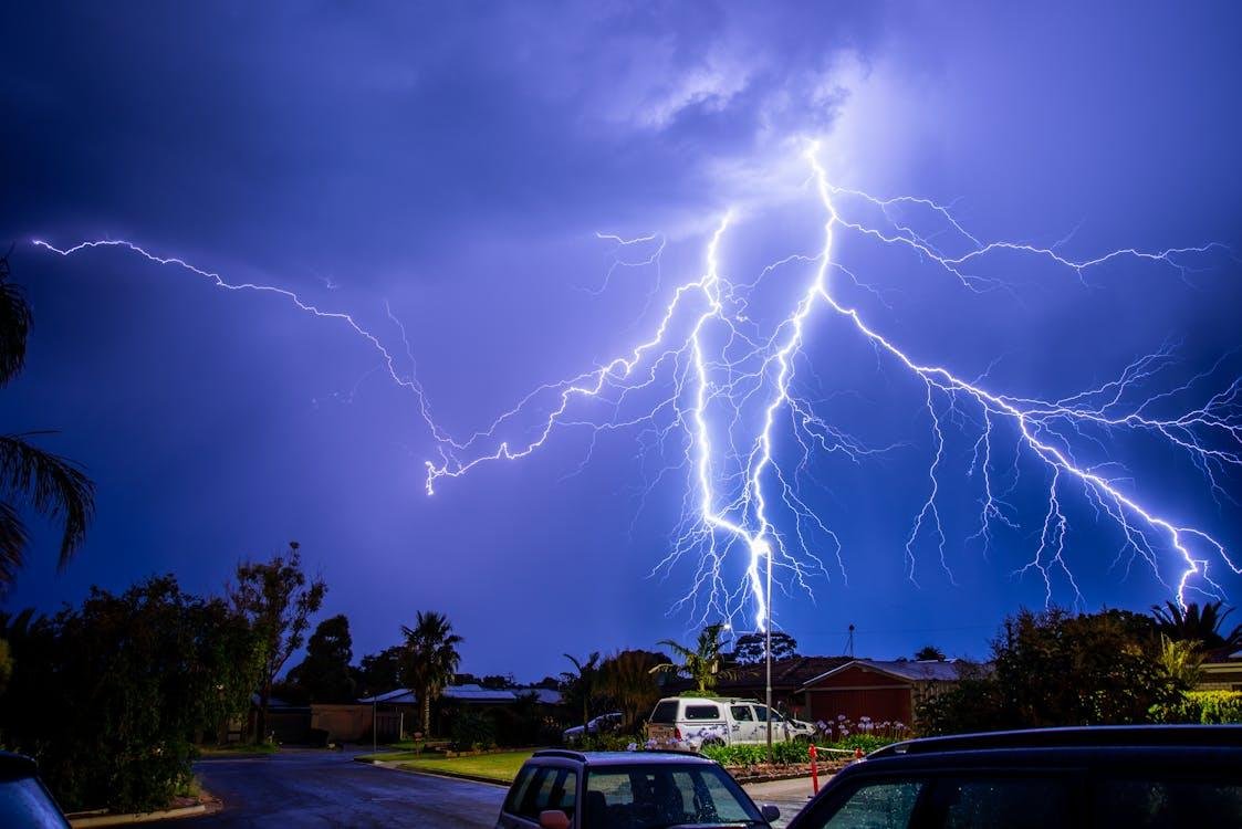 Lightning storm over suburban neighborhood at night.